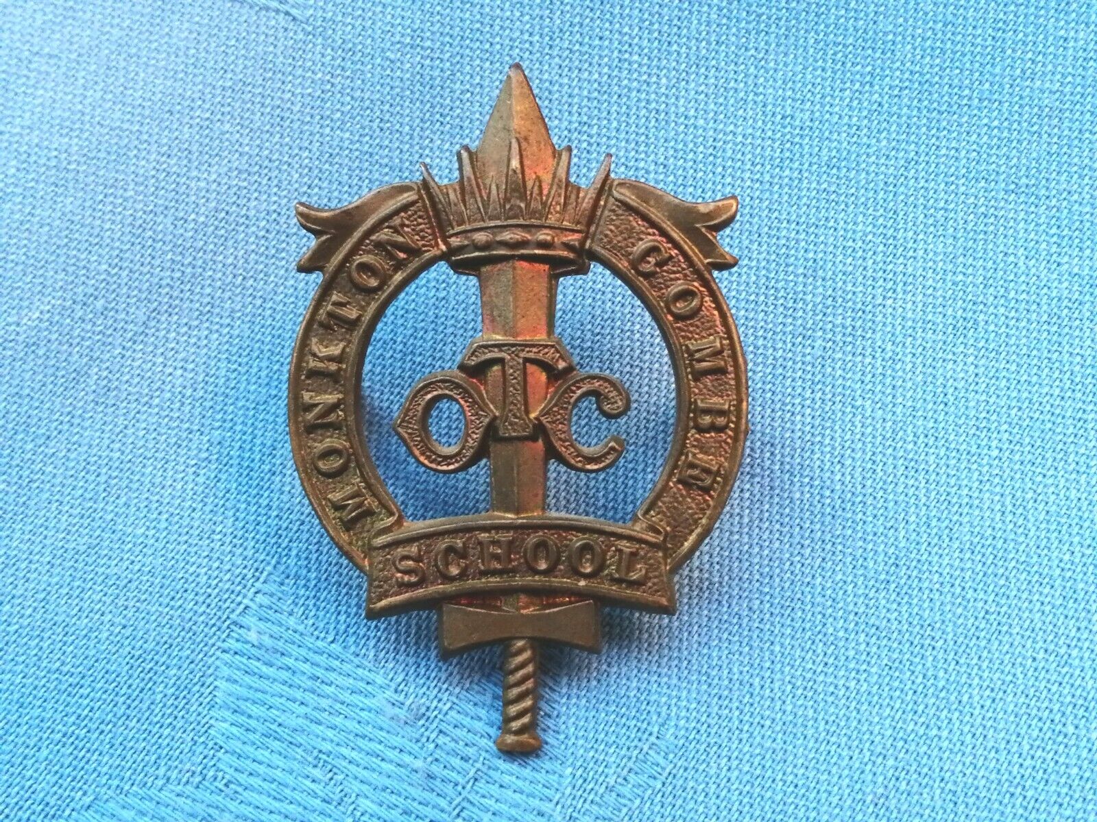 The Monkton School ( Bath ) Officer Training Corp cap badge.