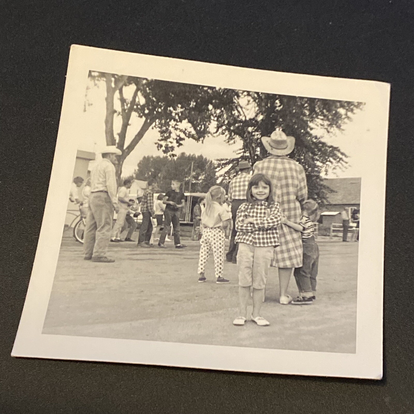 VTG Black & White Snapshot Photo Little Girl Western Wear in Street Cowboys