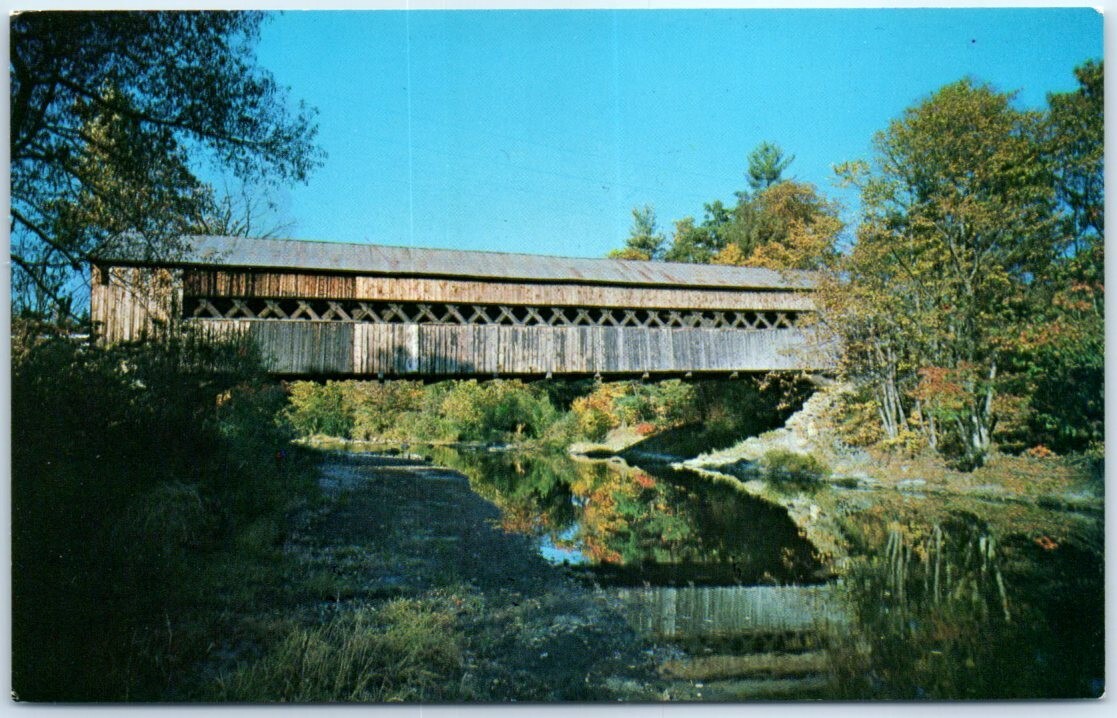 A picturesque setting of an old covered bridge spanning the Saxtons River - VT A picturesque setting of an old covered bridge spanning the Saxtons River - VT