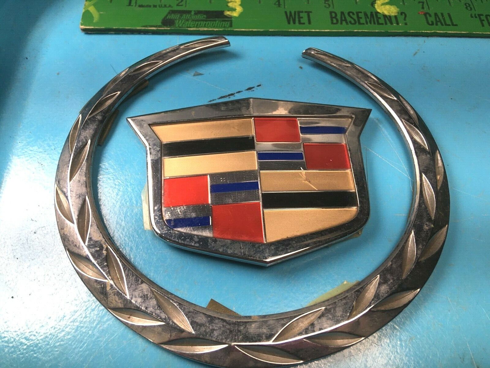 used emblem, caddillac seven inch ring and shield, used good, small rock crack,