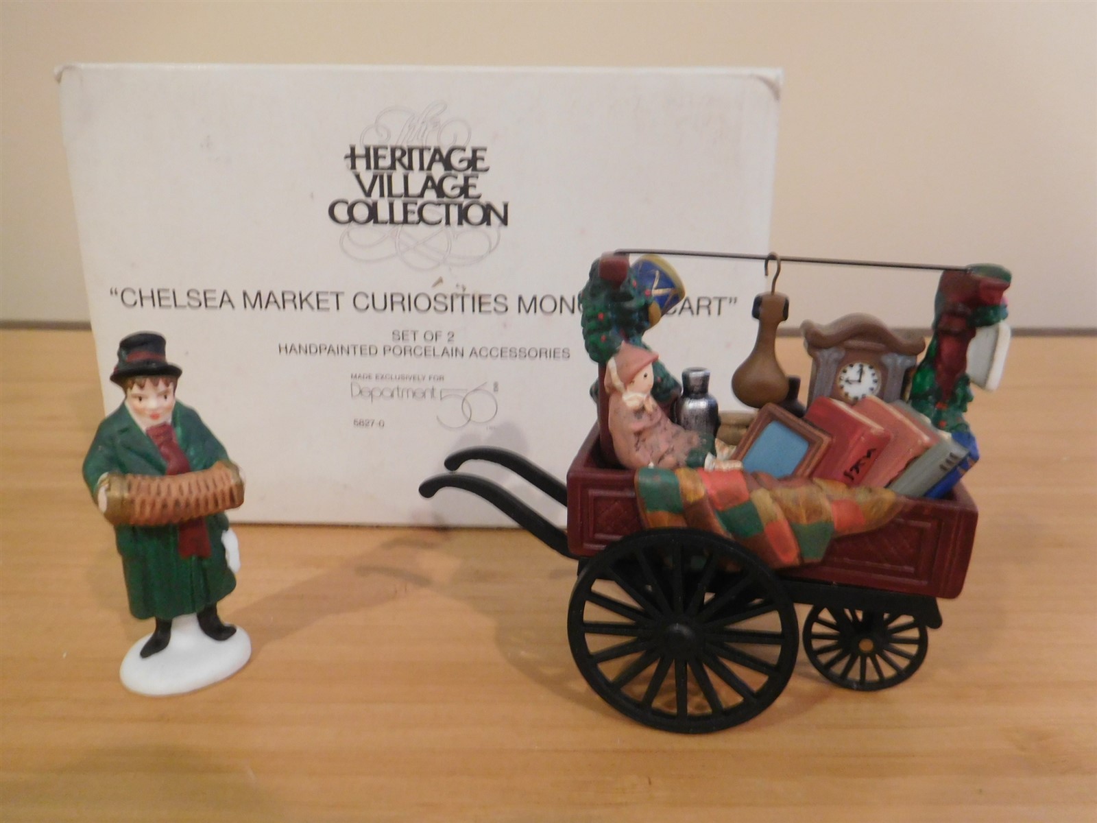 Dept 56 Dickens Village - Chelsea Market Curiosities Monger & Cart - Set of 2 Dept 56 Dickens Village - Chelsea Market Curiosities Monger & Cart - Set of 2