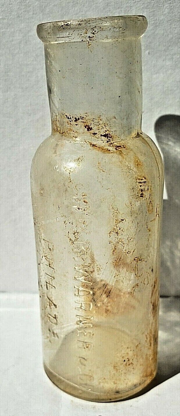Antique, clear glass, round medicine bottle. 